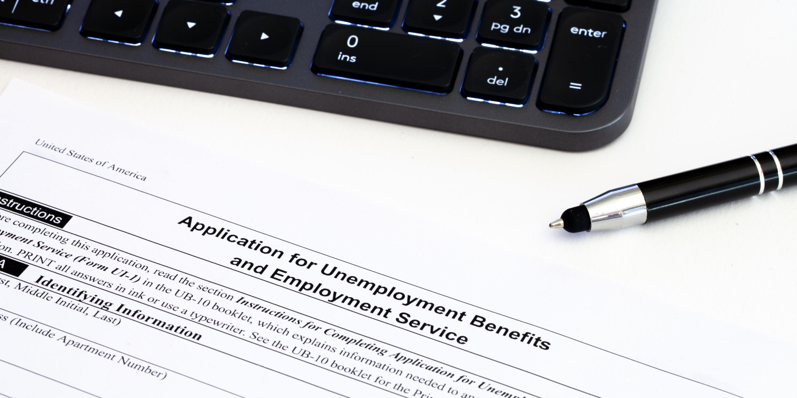 Application,For,Employment,Benefits,Form,With,Computer,Keyboard,And,Pen