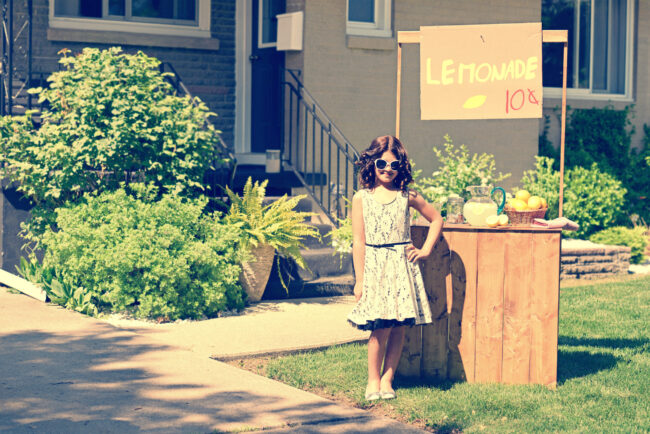 Retro,Girl,Wearing,Sunglasses,With,Lemonade,Stand