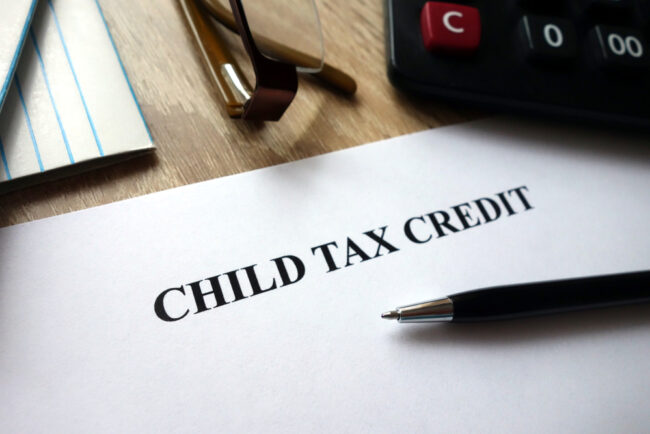 Child,Tax,Credit,Document,With,Pen,,Calculator,And,Glasses,On