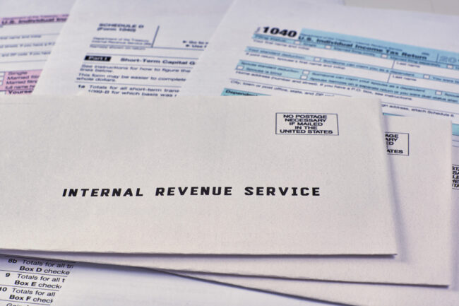 Three,Mails,From,The,Internal,Revenue,Service,Lie,On,1040,