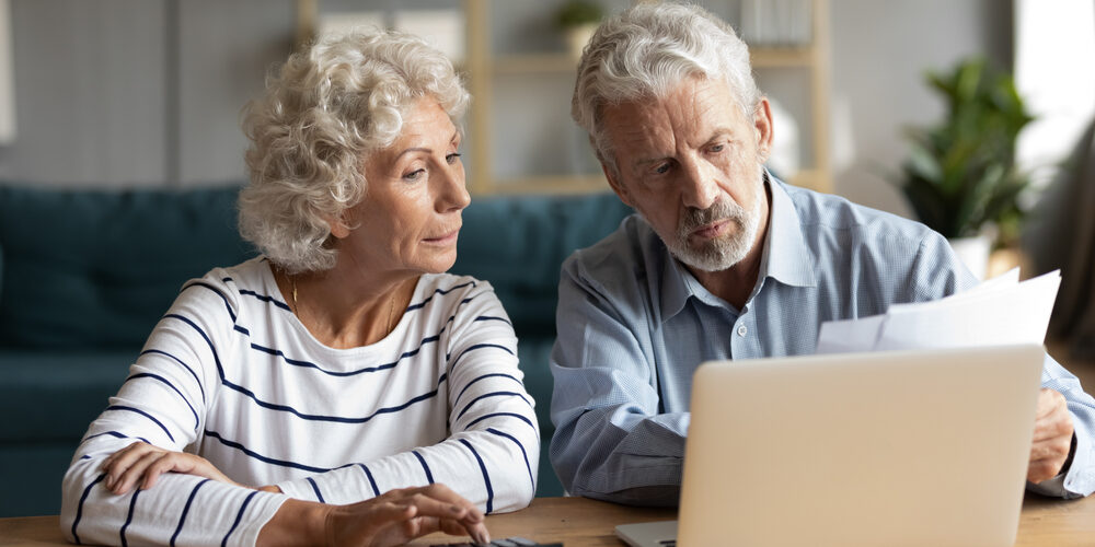 Focused,Middle,Aged,Retired,Family,Couple,Managing,Monthly,Budget,,Involved