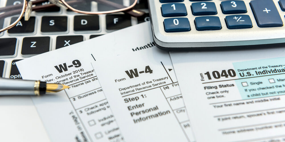 Financial,Time,Tax,Form,With,Laptop,And,Calculator.,Office,Paperwork.