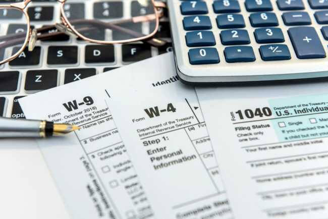 Financial,Time,Tax,Form,With,Laptop,And,Calculator.,Office,Paperwork.