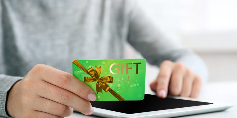 Woman,With,Gift,Card,And,Tablet,,Closeup.,Shopping,Online.,Holiday