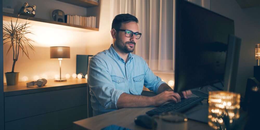 Modern,Young,Man,Working,Remotely,From,Home,At,Night.