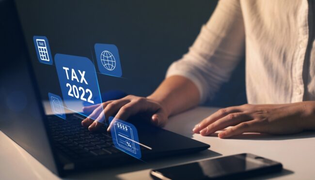 Businesswoman,Using,The,Laptop,To,Fill,In,The,Income,Tax