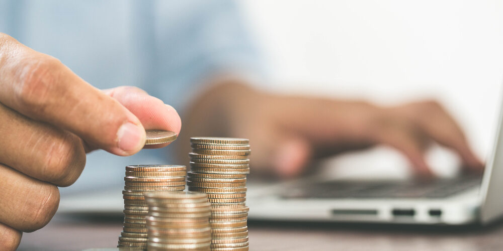Man’s,Hand,Put,Money,Coins,To,Stack,Of,Coins.,Concept