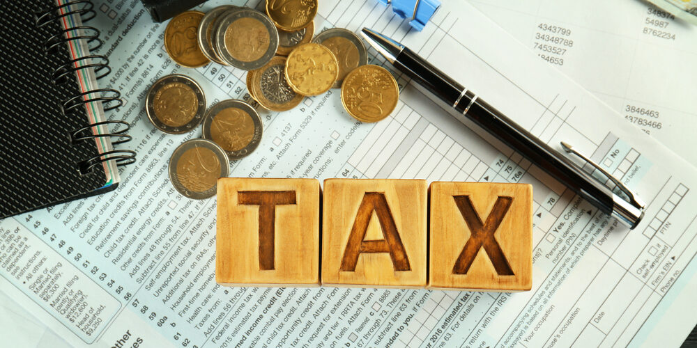 Wooden,Blocks,With,Word,Tax,On,Documents