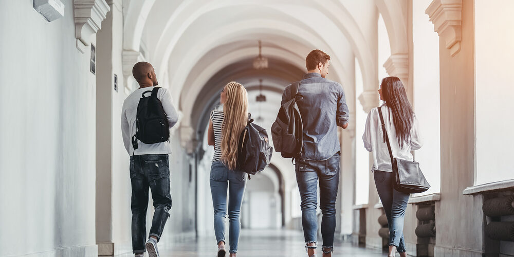 Multiracial,Students,Are,Walking,In,University,Hall,During,Break,And