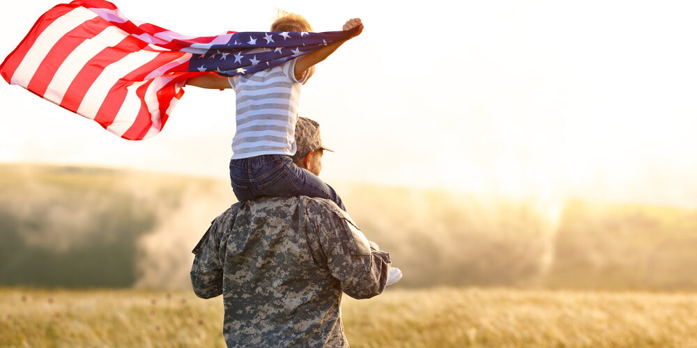 Rear,View,Of,Military,Man,Father,Carrying,Happy,Little,Son