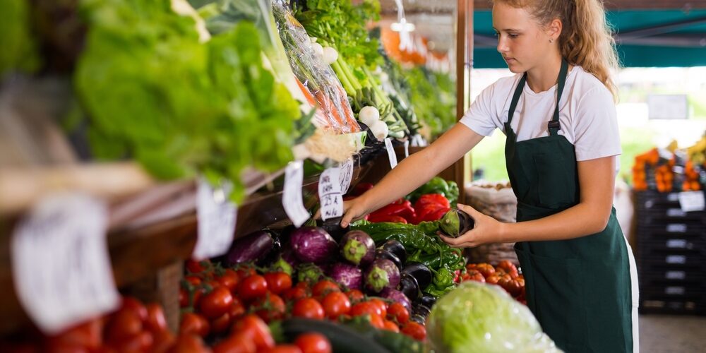 Young,Girl,Seller,In,Uniform,Working,In,Supermarket,At,Her