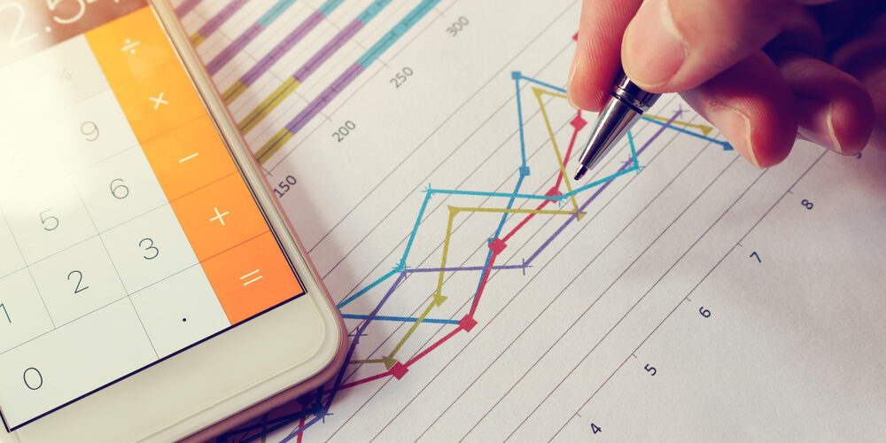 Businessman,Holding,Pen,And,Think,With,Cost,With,Calculator,In