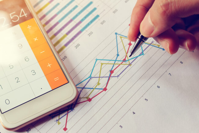Businessman,Holding,Pen,And,Think,With,Cost,With,Calculator,In