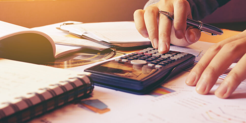 Woman,Using,Calculator,With,Doing,Finance,At,Home,Office.
