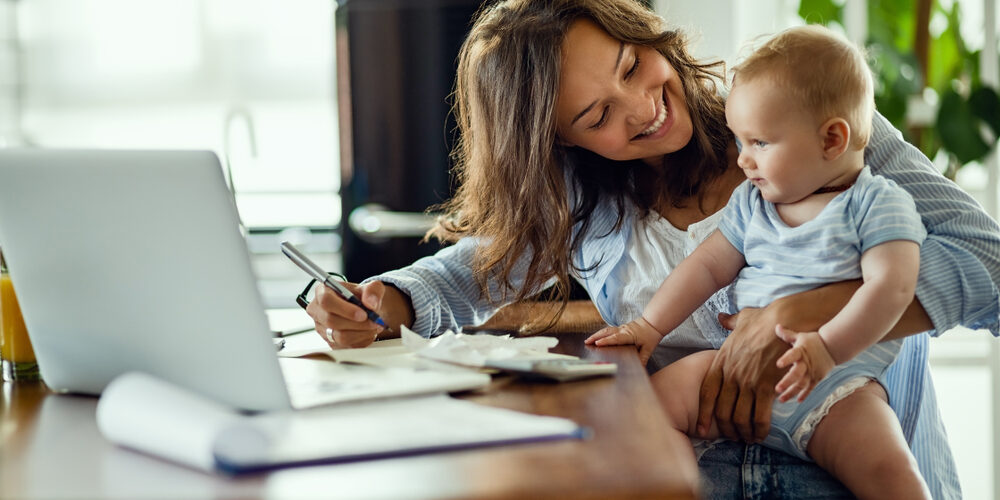 Young,Happy,Mother,Going,Through,Home,Finances,And,Communicating,With