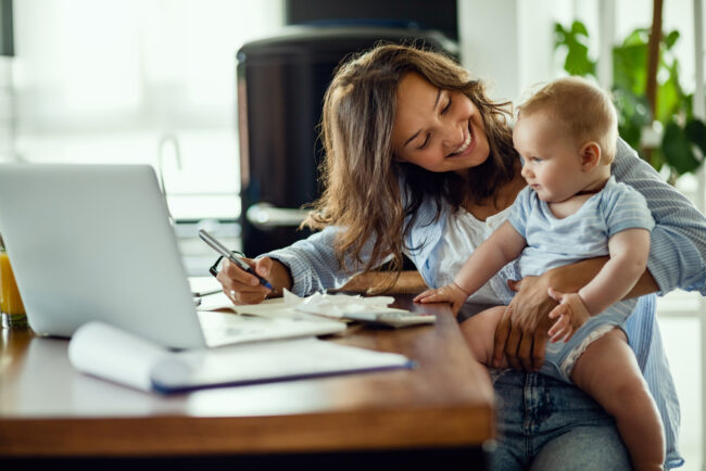 Young,Happy,Mother,Going,Through,Home,Finances,And,Communicating,With