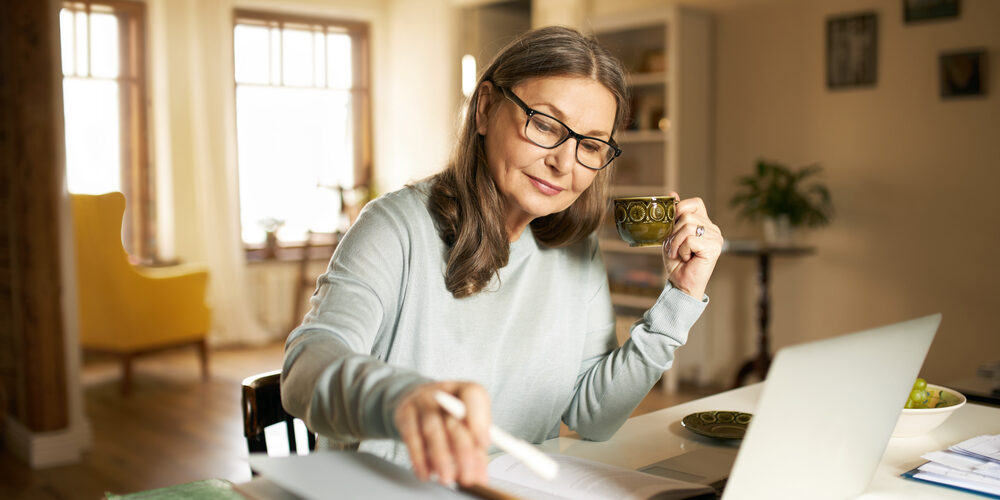 Serious,Confident,Middle,Aged,Female,Journalist,With,Cup,Of,Coffee