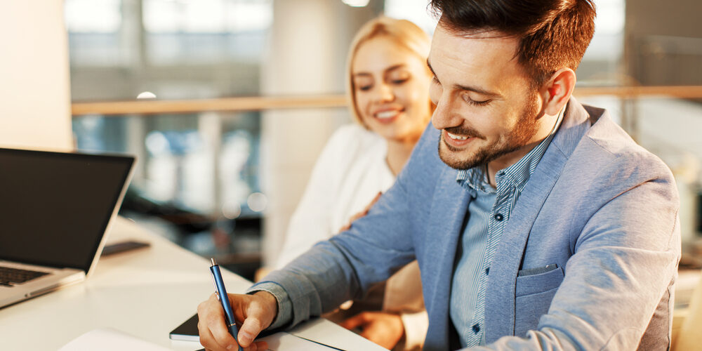 Young,Business,Couple,Signing,A,Contract